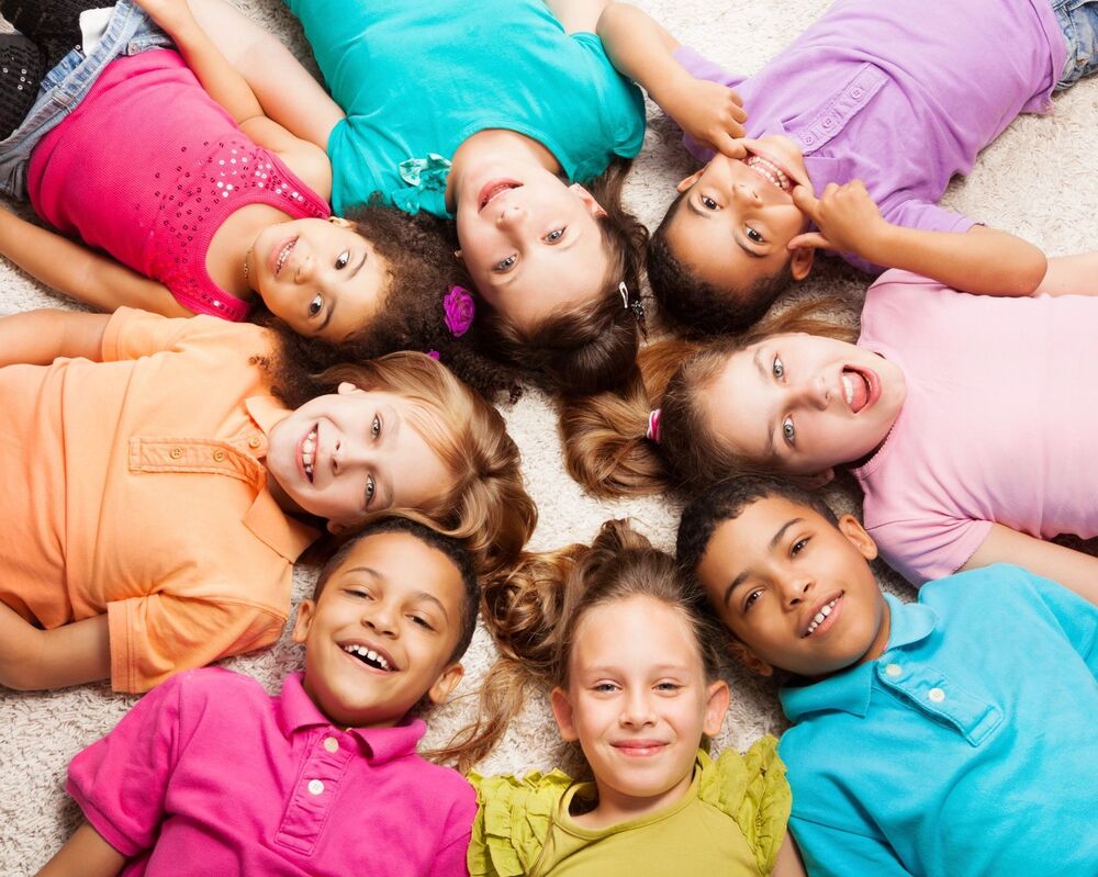 kids laying on the floor smiling