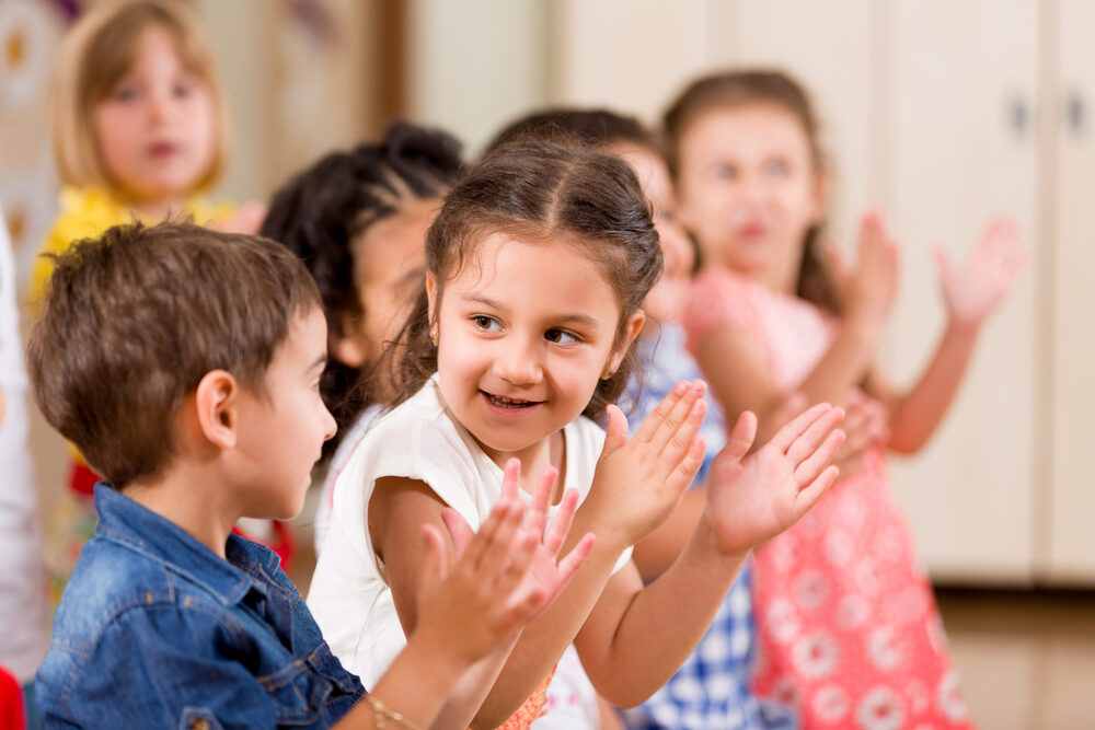 Children clapping in classroom