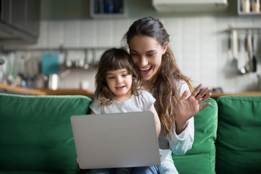 adult and kid looking into a computer