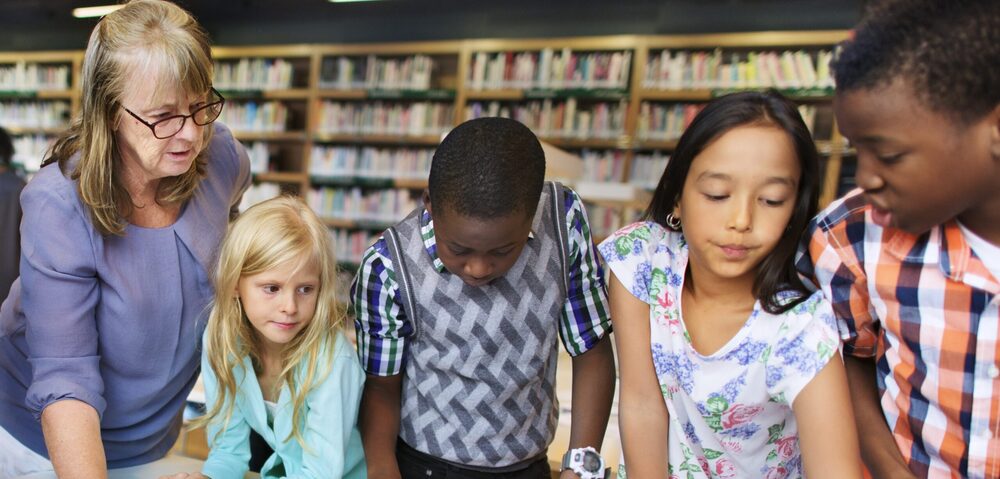 kids and teacher in library