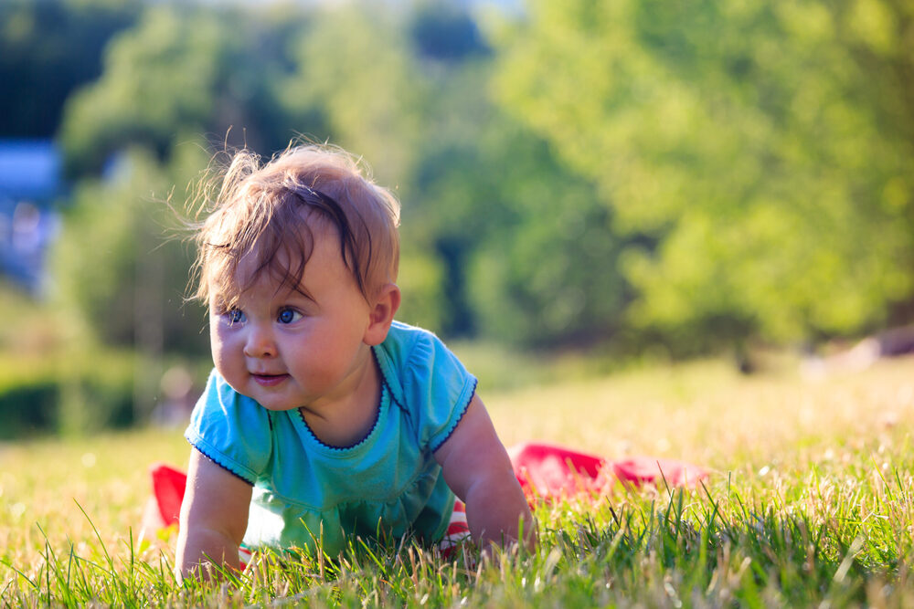 baby playing on the grass