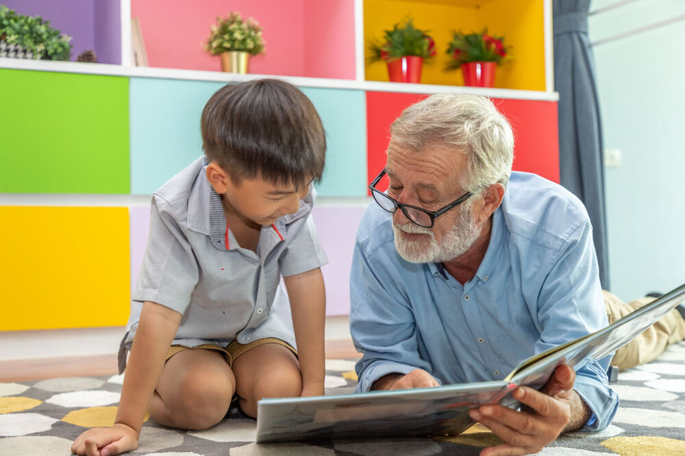 kid and adult reading a book
