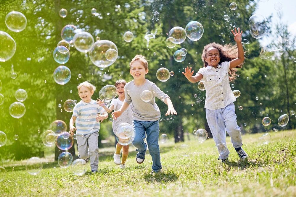 kids playing outside with bubbles