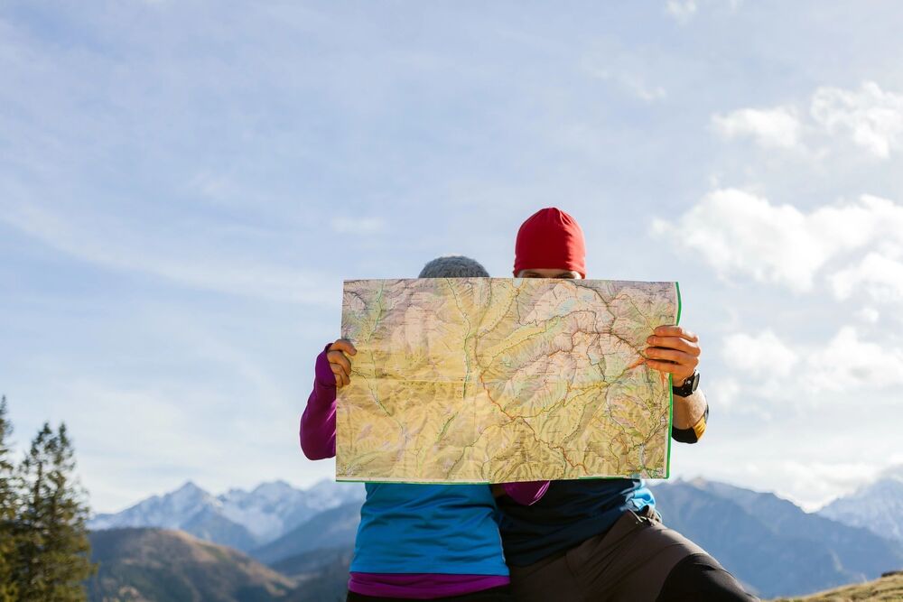 2 people reading a map outdoors