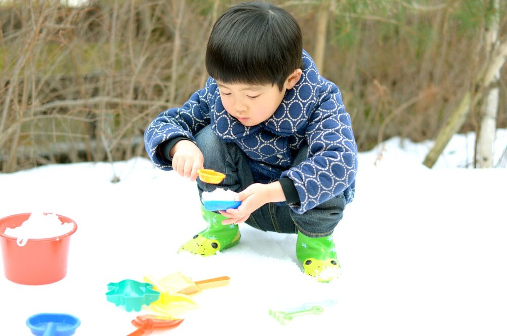 kid playing with sand