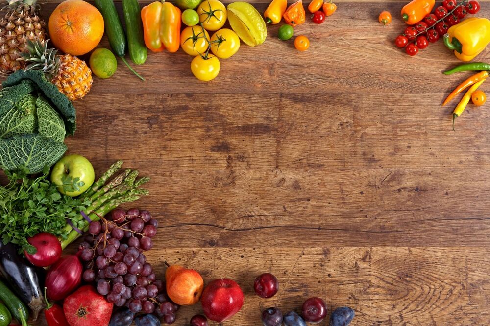 wooden table with fruits and vegetables