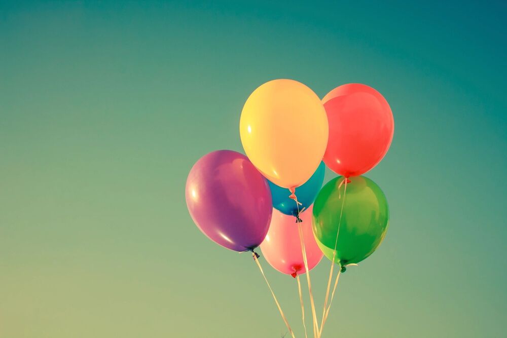 balloons of different colors with green/yellow background