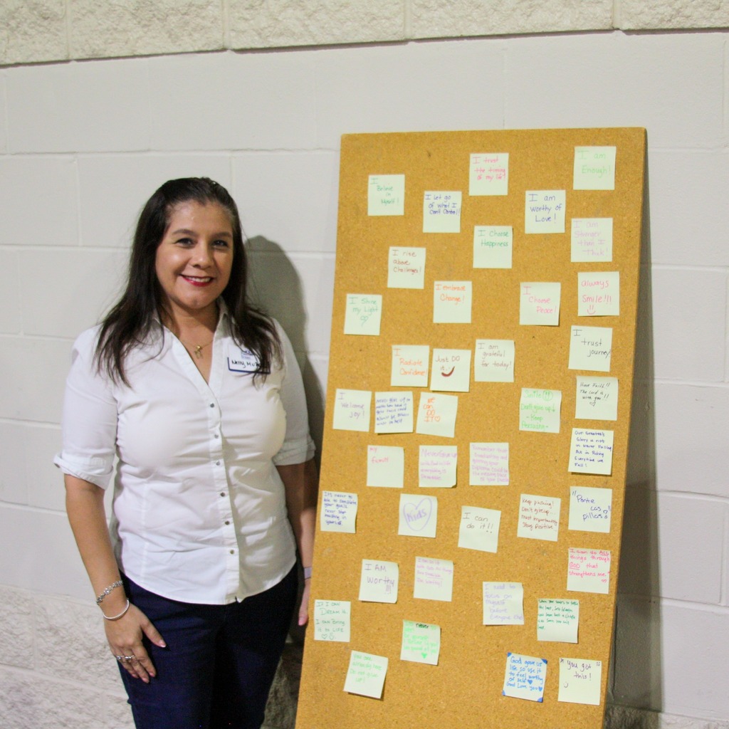 woman posing next to bulletin board