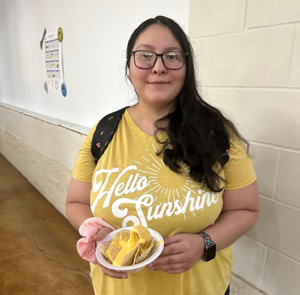 student posing with nacho meal