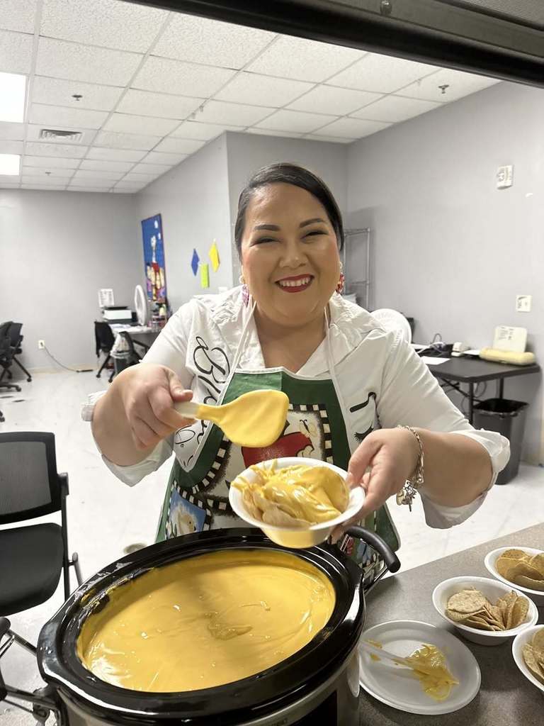 Teacher smiling serving nachos