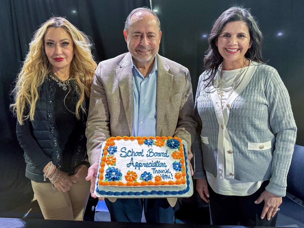three board members posing with a cake that says "school board appreciation thank you"