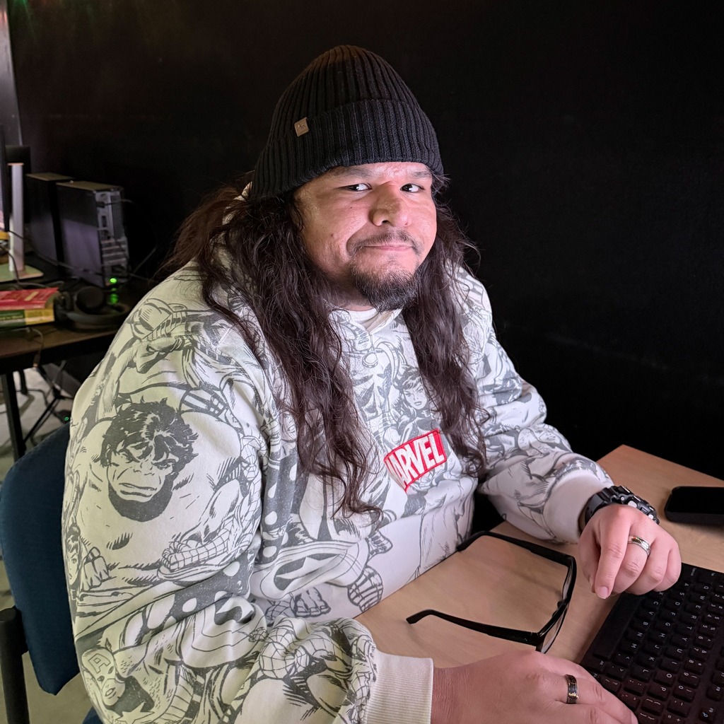 student facing camera at a computer workstation