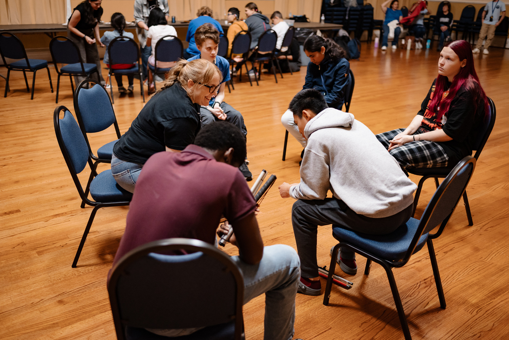 blind departments sitting in a circle and talking to a wayne theatre leader
