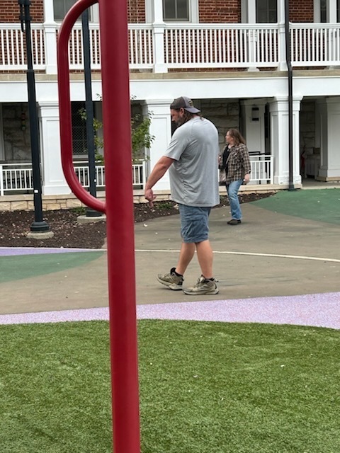 Two VSDB staff members are crossing (and looking around) the courtyard 