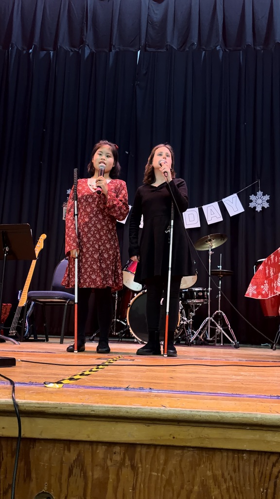 Two students are singing on stage 