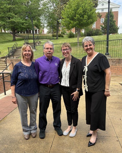 Mr. Charles Schwab, Mary Beth Schwab, Lindsay Burris, and Charity Reedy Warigon stand for a photo outside.