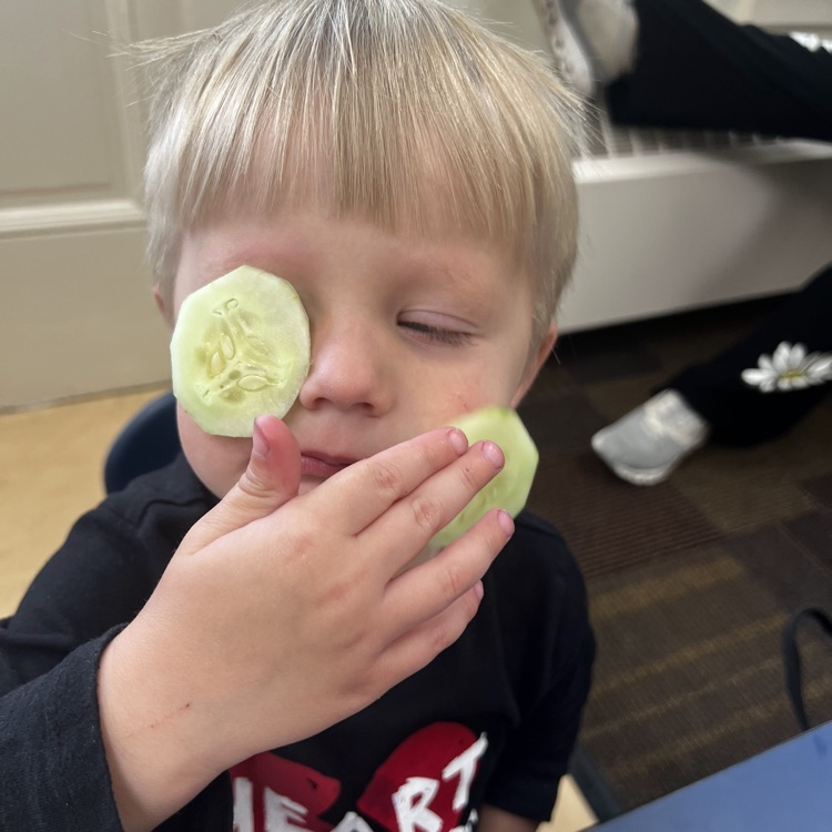young boy with cucumbers on his eyes