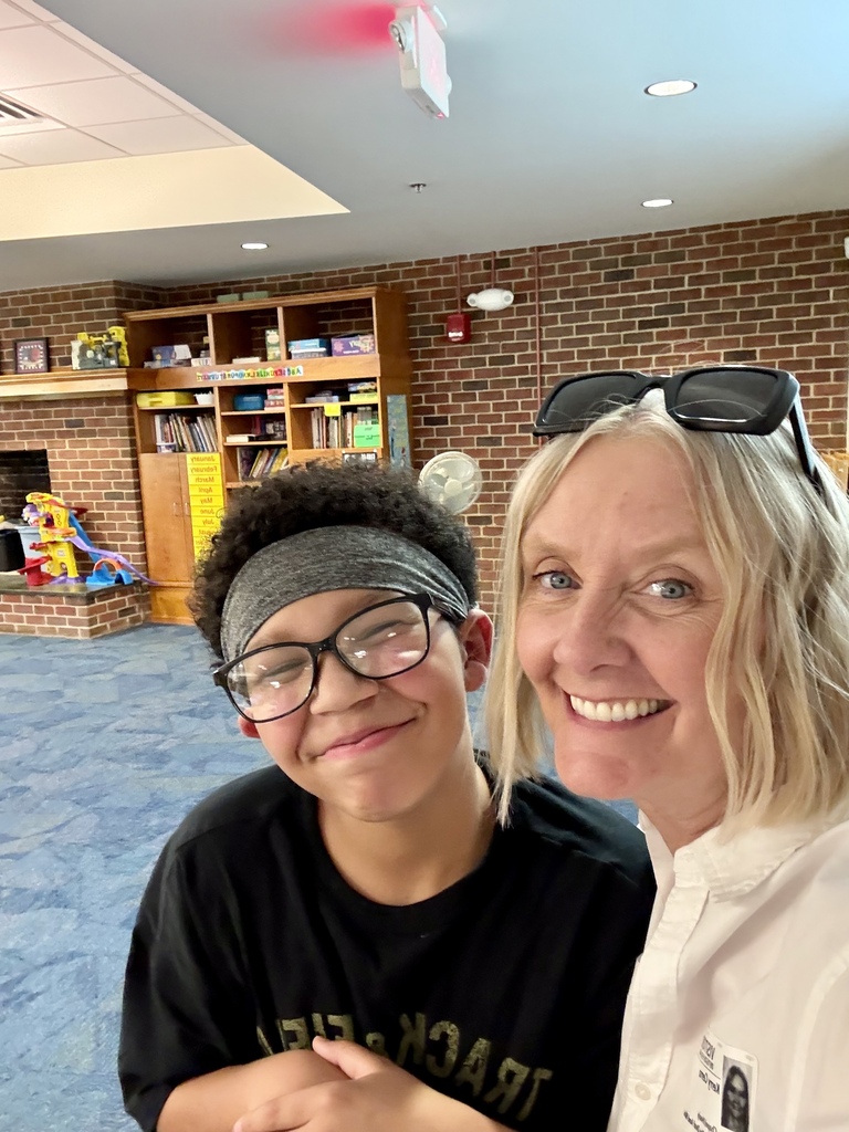 Kerry smiling for a selfie with a student