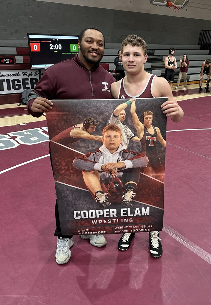 Cooper Elam, a member of the THS Tigers wrestling team, earns his 100th win Jan. 21 against Hale County in the THS gym. He is pictured with former THS wrestling standout Orlando Gildersleeve.