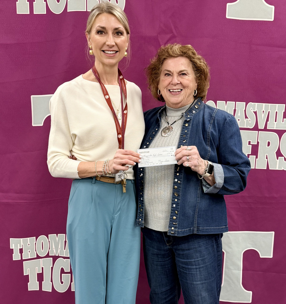 Sherian Newton of the Thomasville Worthwhile Club (right) presented a donation ($50) to the Thomasville High School library in honor of Miriam Harrison. She is pictured with Elizabeth Ledkins, THS Library Media Specialist.