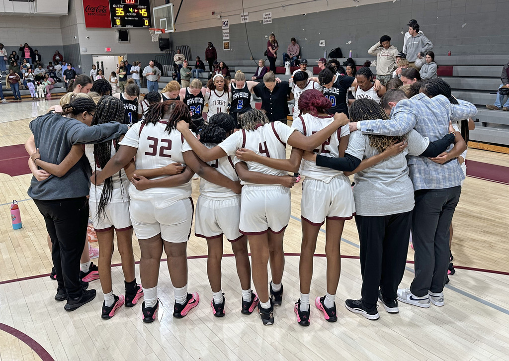 The Thomasville High School Lady Tigers basketball team and coaches prayed with the Bayside Academy Lady Admirals team and coaches Feb. 13 after the sub-regional game.