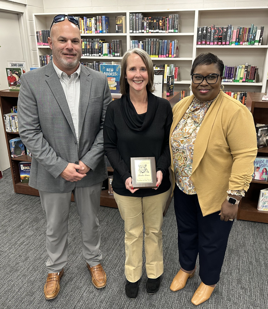 Phala Mims (center), Seventh Grade Math Teacher, was honored as "Teacher of the Year" 25-26 at Thomasville Middle School. She is pictured with Brad Elam, TMS Principal; and Renae Williams, TMS Assistant Principal.