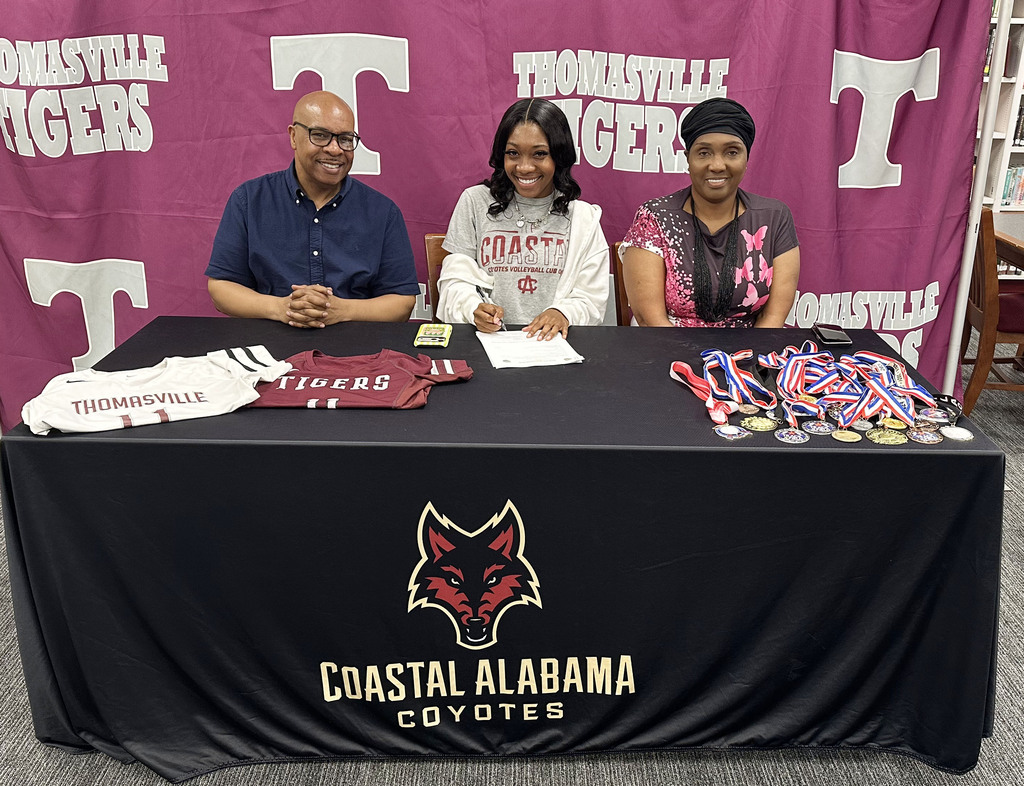 Lyric Thompson, a senior at Thomasville High School, has signed with Coastal Alabama Community College in Bay Minette to play volleyball. A ceremony was held May 15 in the school library. Pictured are Kevin Thompson, father; Lyric Thompson; and Twanda Pugh Allen, mother.