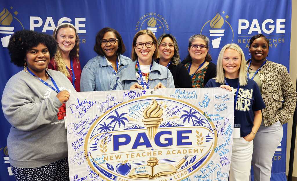 A group of women holding a sign with the word "PAGE" standing next to each other.