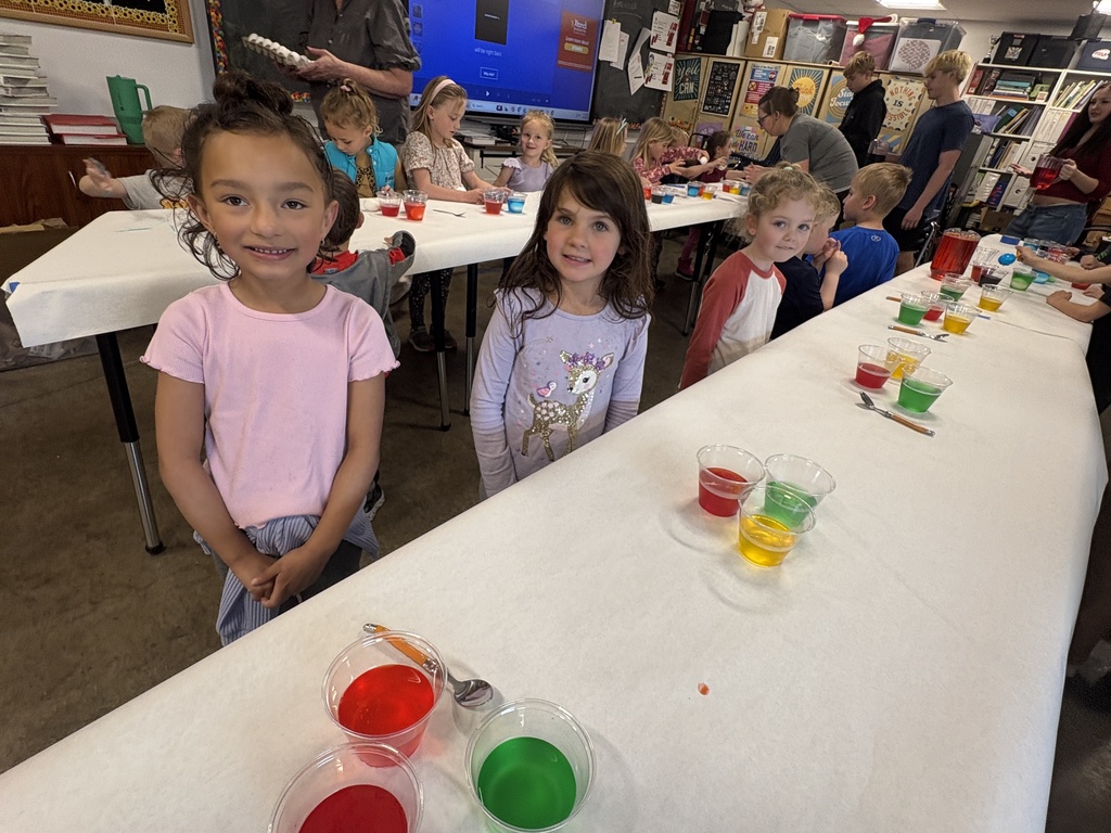 PreK students dying Easter eggs with the high school child development students.