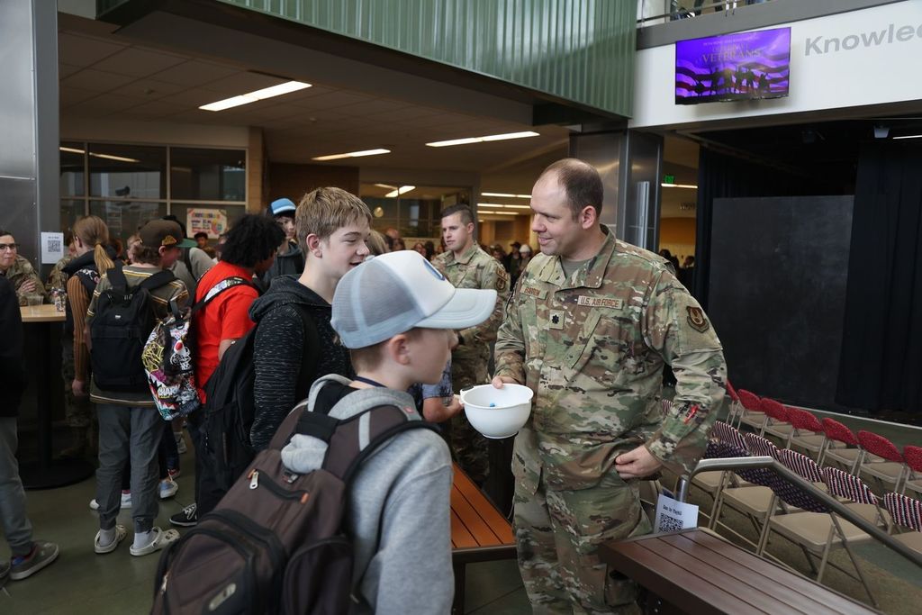 students talking to military member
