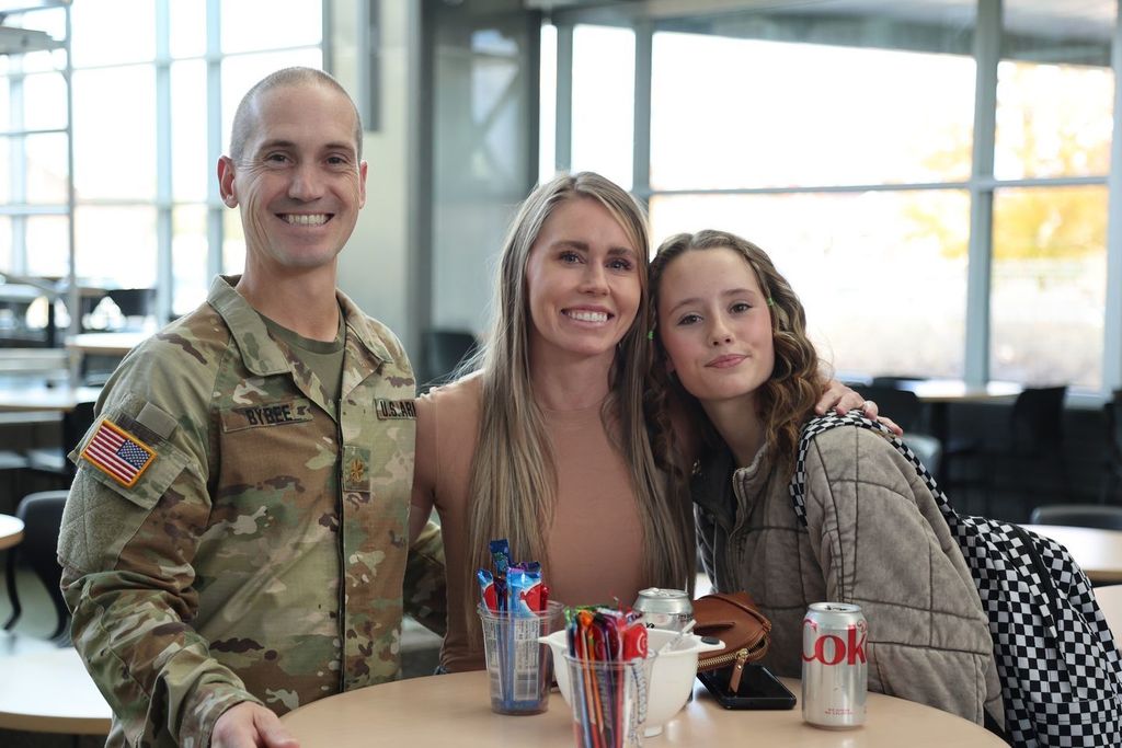 students talking to military member