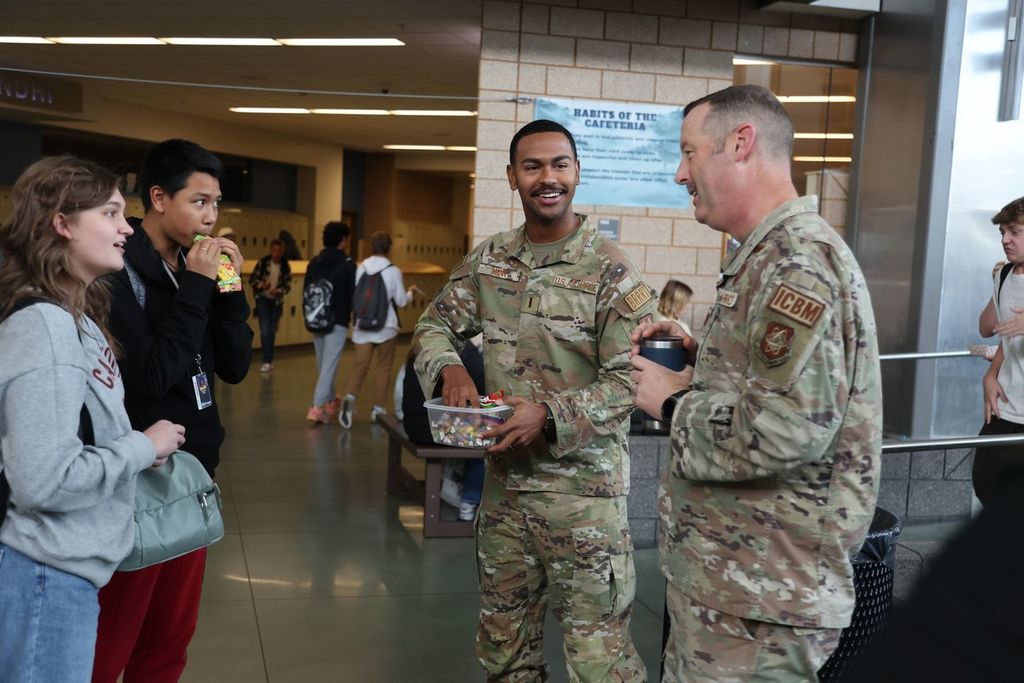 students talking to military member