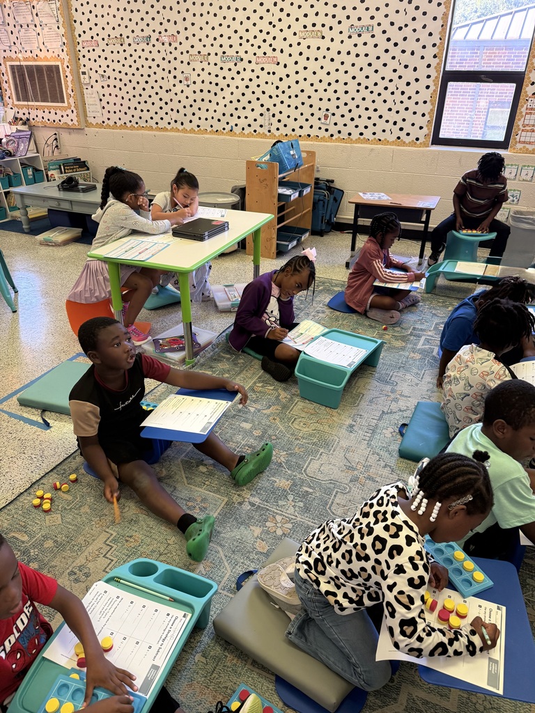 Mrs. McRae’s class is practicing math how they learn best! They chose from flexible seating options including different chairs, desks or floor desks. They also got to choose to complete the math problems using any strategy that works for them! Some students chose to use 10 frames, others used number lines or drew pictures! Then they shared what works for them, and how they got their answers to the same problems!