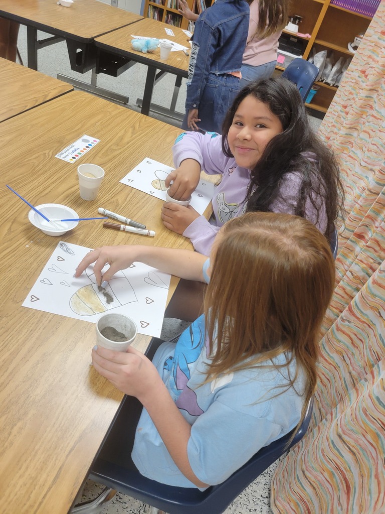 Students creating sand art.