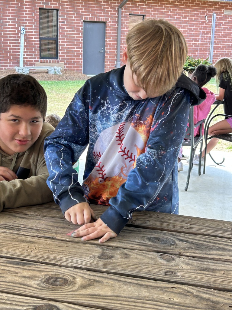 5th graders compleing a science lab.