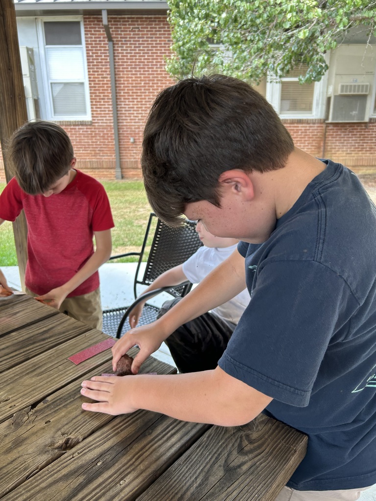 5th graders compleing a science lab.