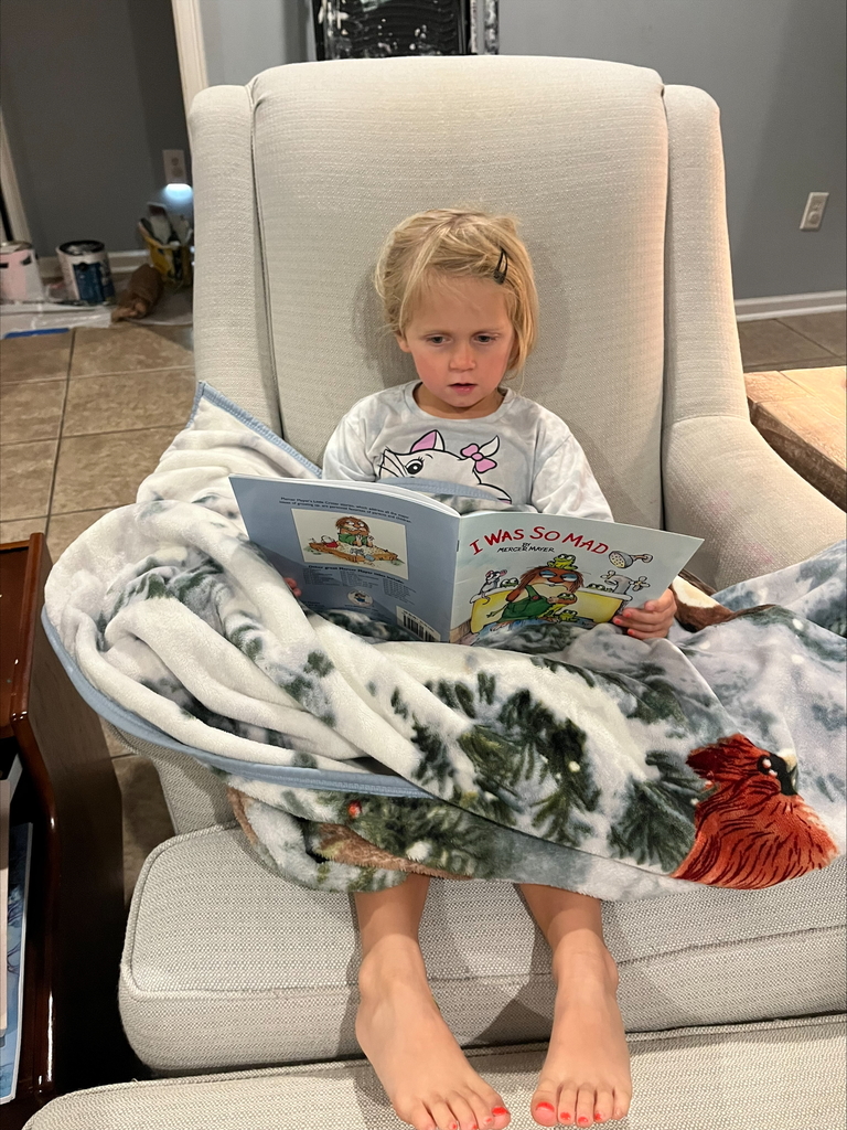 Skylar Baughman in a comfy chair and warm blanket