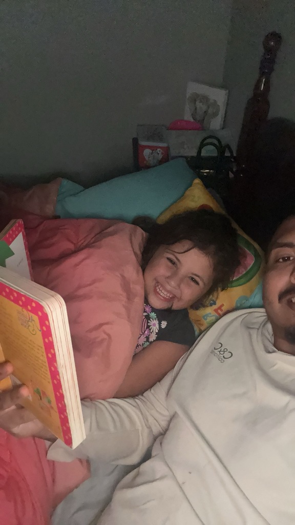 Arianna Pina snuggling up to read with Dad