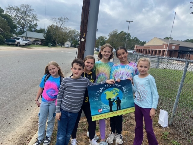 Student council members supporting the Go Light Up Your World Event.