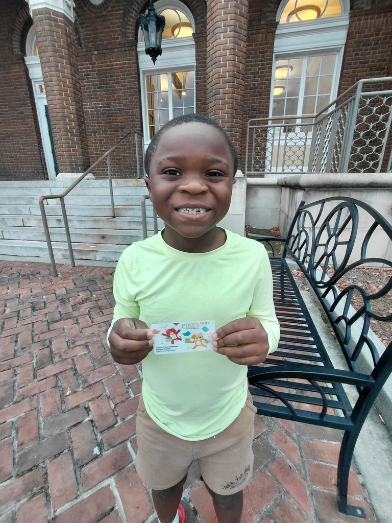 Dior Smith shows off his library card.