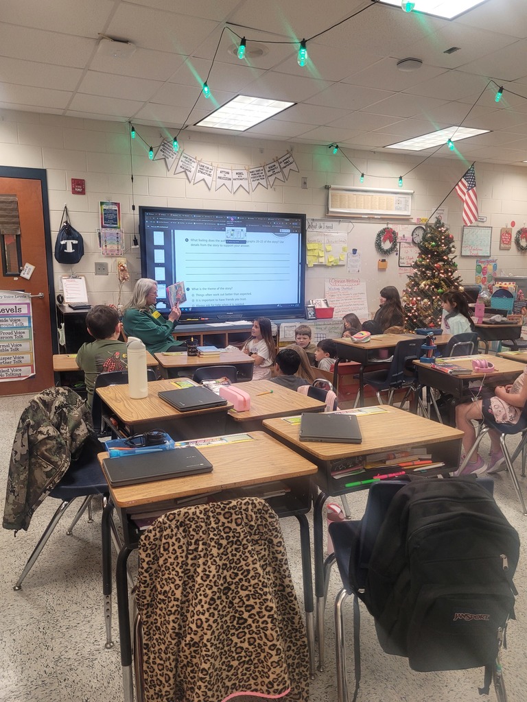 A grandparent reading to Mrs. Overman's 3rd grade class at Omega Elementary School.