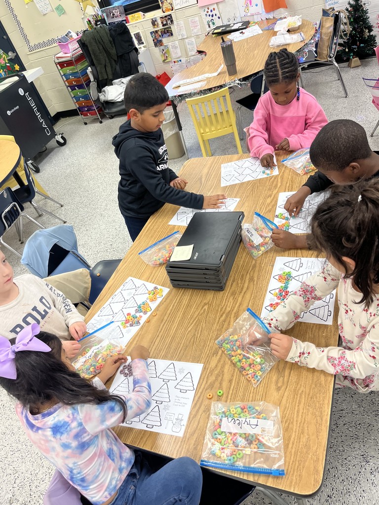 Kindergarten students practice counting by tens with Christmas trees.