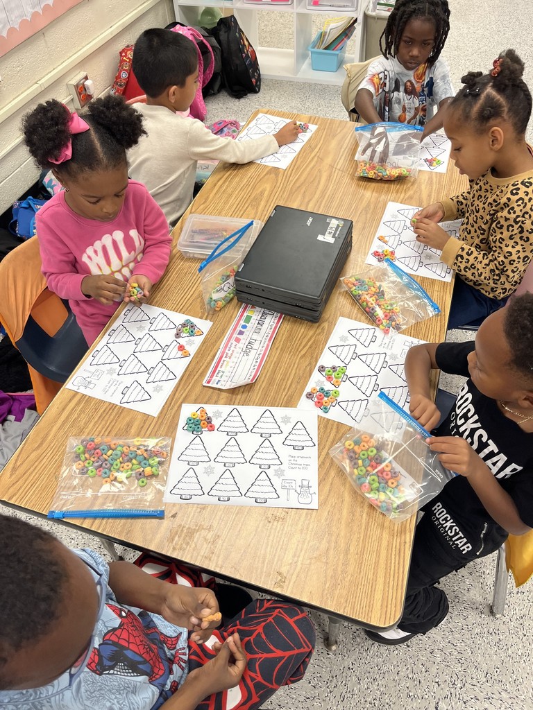 Kindergarten students practice counting by tens with Christmas trees.
