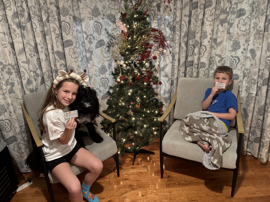 Two students show off their public library cards.