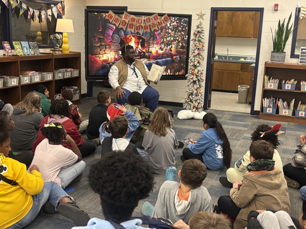 Mr. Dean and Mrs. Lee read a holiday story to each grade level.