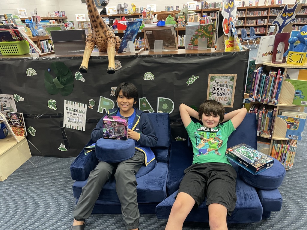 1,000,000 word book club founding members on a couch in media center.