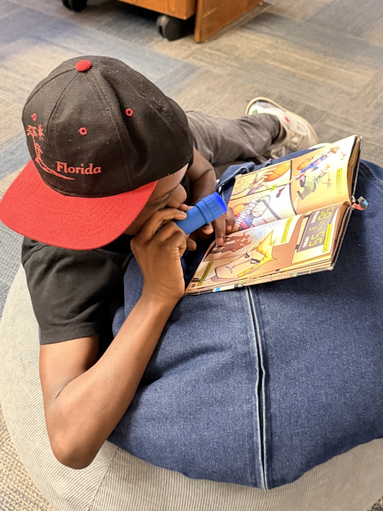 Students read with flashlights to celebrate Read Across America!