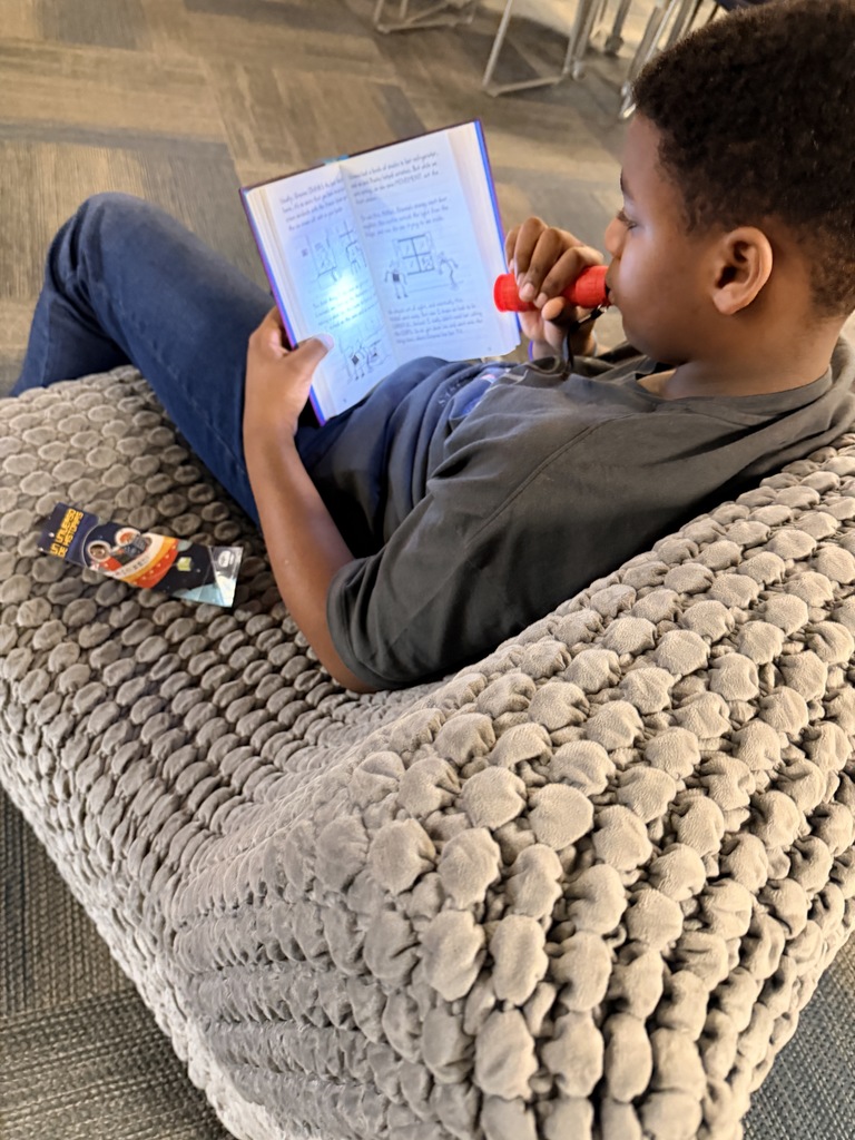 Students read with flashlights to celebrate Read Across America!