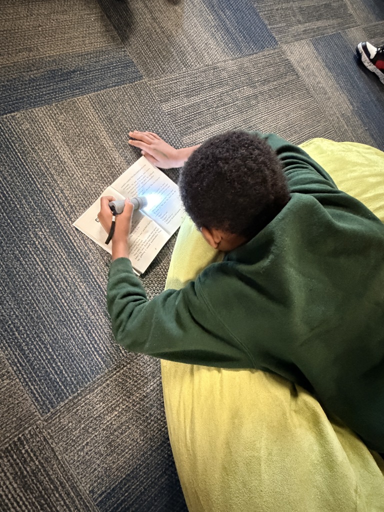 Students read with flashlights to celebrate Read Across America!