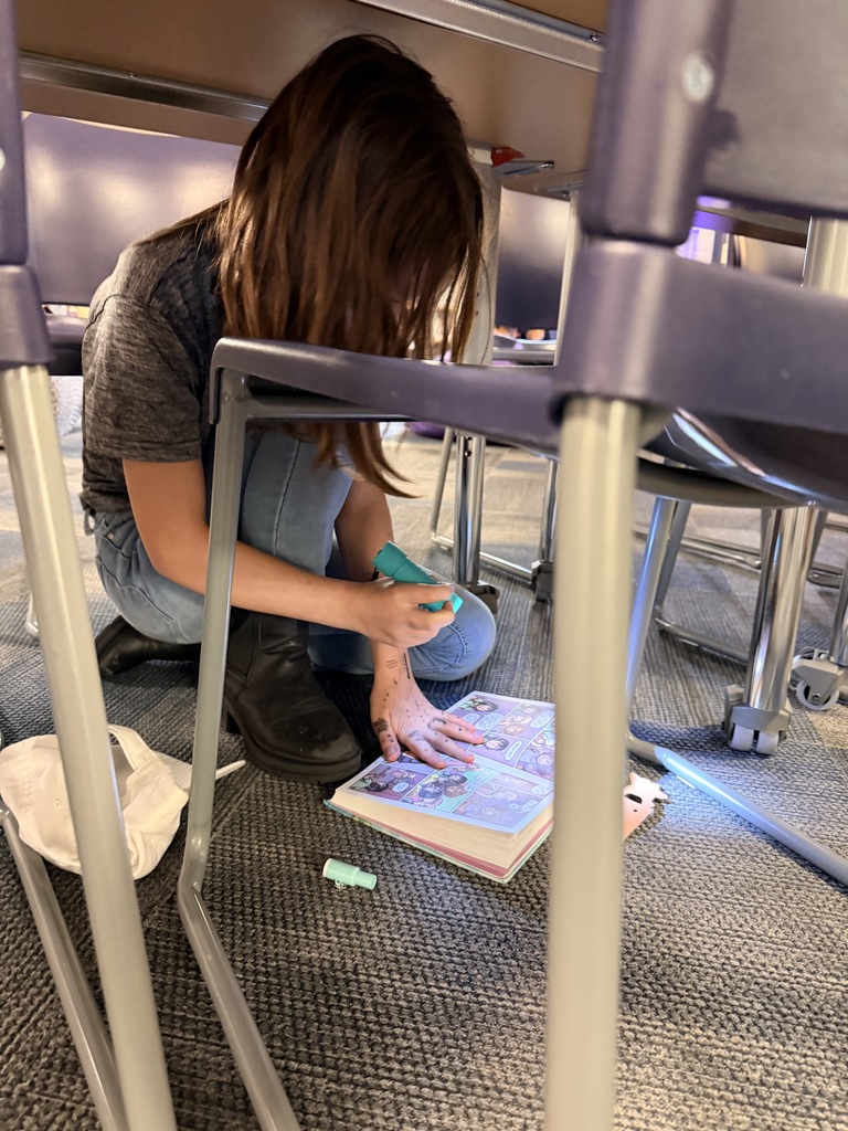 Students read with flashlights to celebrate Read Across America!